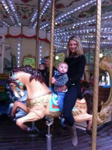 Helen and Yianni A photo of Helen and Yianni riding a leaping horse on a carousel